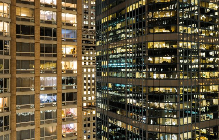 Residential and office buildings are pictured at night in New York.