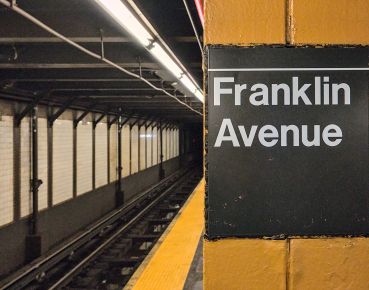 Franklin Avenue sign on platform inside subway station