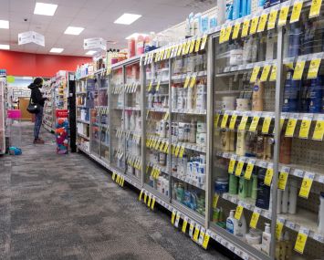 CVS with locked cases to prevent theft, Philadelphia, Pennsylvania, USA.