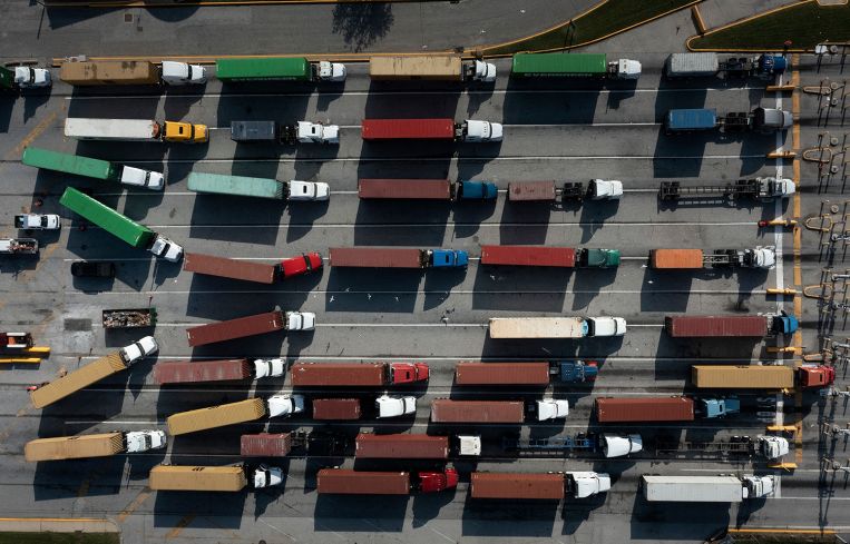 Trucks transport cargo containers