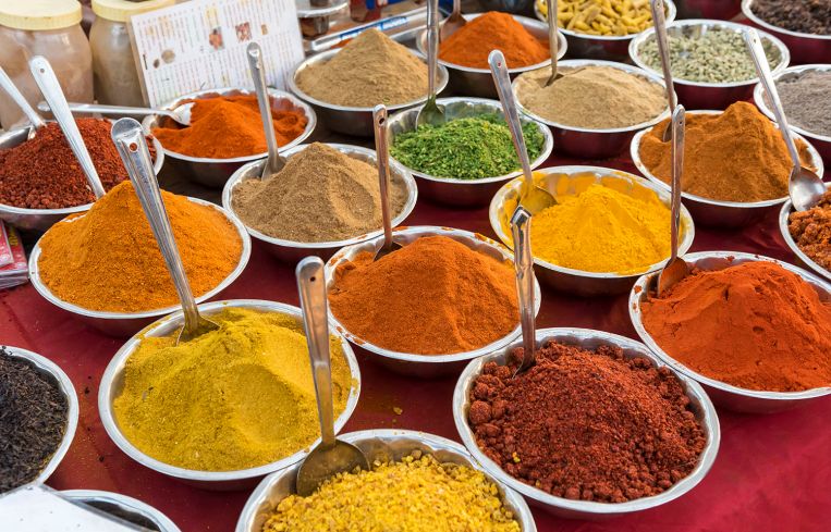Spices, herbs and curry powders on display.