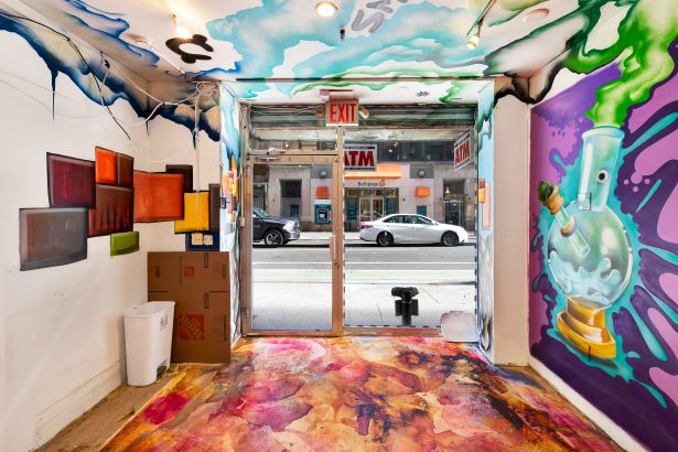 The brightly painted interior of a vacant storefront looking out towards West 26th Street in Manhattan.