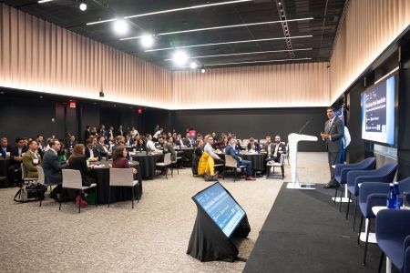 Sam Chandan, founder of the Real Estate Pride Council, speaks at the group’s now annual conference at Deutsche Bank’s Manhattan offices in April. The event drew more than 350 attendees from over 150 firms. A kickoff dinner two years ago drew about 25 people.