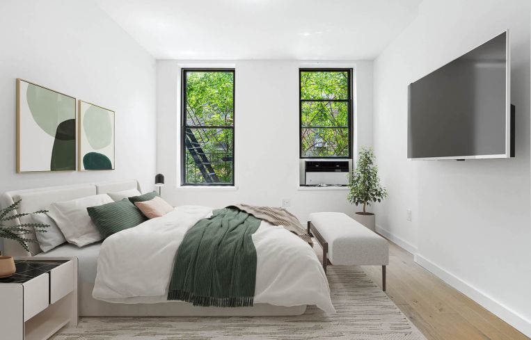 A bedroom with two windows.