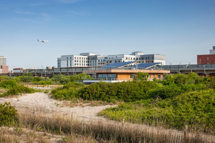 A wide view of the Welcome Center amid an large undeveloped area of dunes and beach grass.
