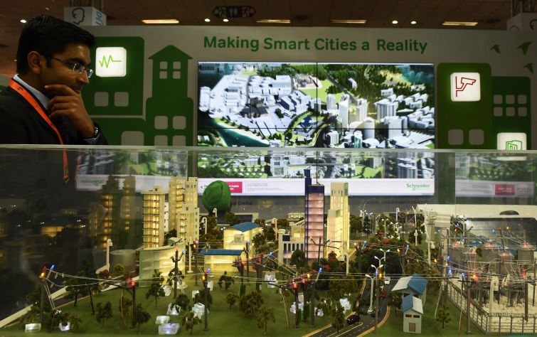 An Indian visitor looks at a model of a smart city at the Smartcity Expo in India's New Delhi in 2015.
