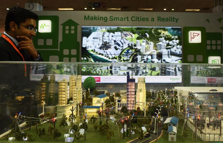 An Indian visitor looks at a model of a smart city at the Smartcity Expo in India's New Delhi in 2015.
