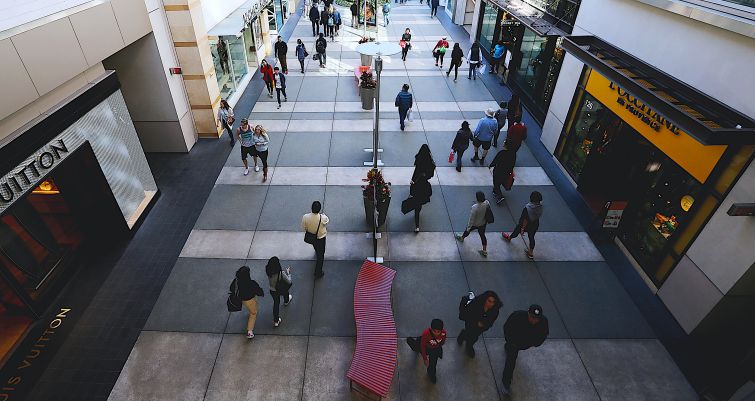 Shoppers walk between stores at Santa Monica Place in Santa Monica.