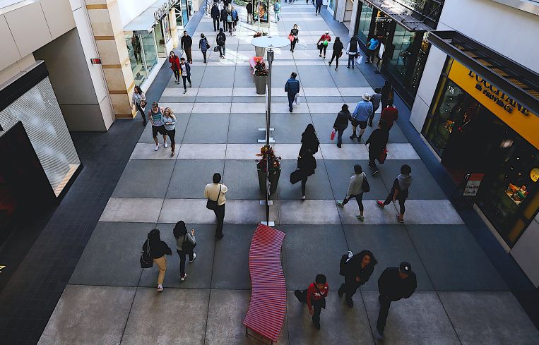 Shoppers walk between stores at Santa Monica Place in Santa Monica.
