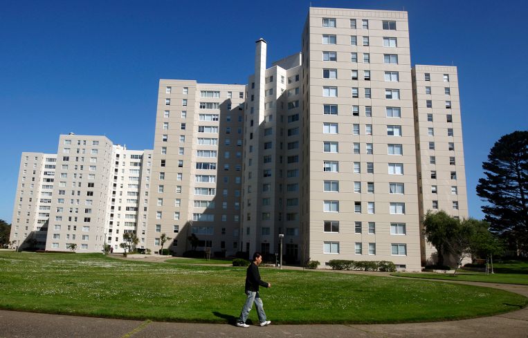 A resident walks through the grounds of the Park Merced neighborhood in San Francisco.