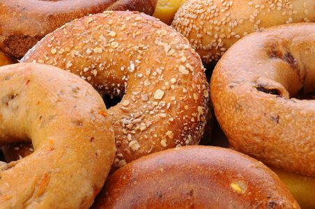 Closeup of assorted bagels, including sesame seed, egg bagel, mulit-grain, cinnamon raisin and plain.