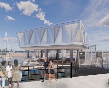 People running on the waterfront past a dock house on trusses over the water.