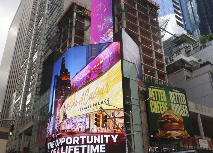 A commercial building covered in billboards in Times Square, New York.