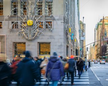 New York USA - Blurred people at a busy intersection in front of the flagship Tiffany's store with Christmas decorations on Fifth Avenue in Manhattan