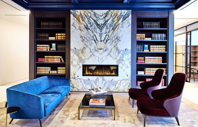 A blue couch and pair of purple accent chairs forming a cluster of seating.