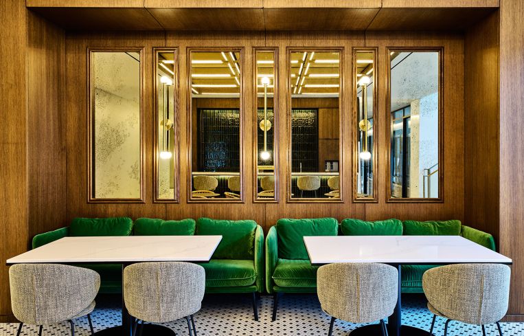 Two café tables against a mirrored wall.