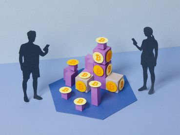 Paper craft illustration of younger people investing to or mining cryptocurrency.