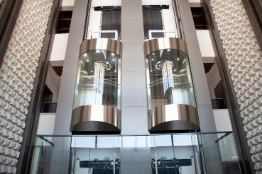 Two cylindrical elevators in mid-suspension.