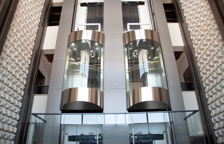 Two cylindrical elevators in mid-suspension.