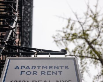 A sign advertising units for rent is displayed outside of a Manhattan building