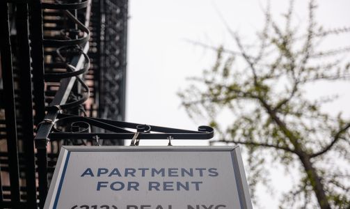 A sign advertising units for rent is displayed outside of a Manhattan building