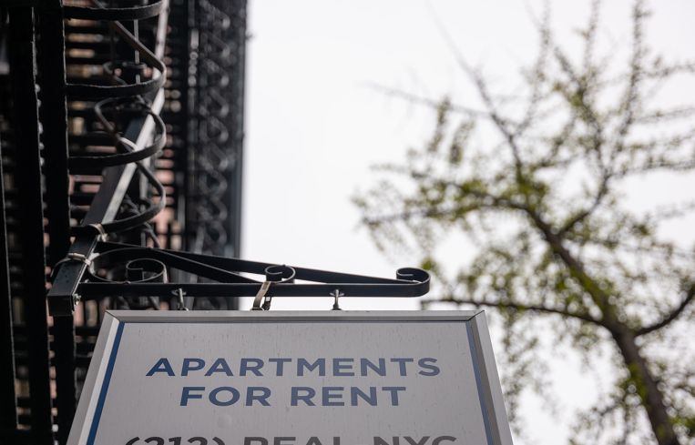 A sign advertising units for rent is displayed outside of a Manhattan building