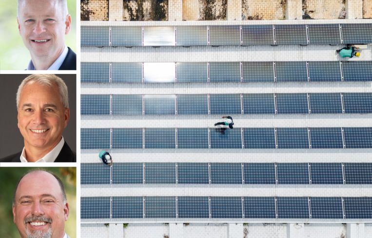 Legence CEO Jeff Sprau, AMA Group CEO Arthur Metzler, CMTA CEO Jimmy Benson, and workers install solar panels on a rooftop.