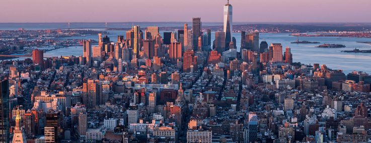 An aerial shot down Manhattan with lots of buildings in view.