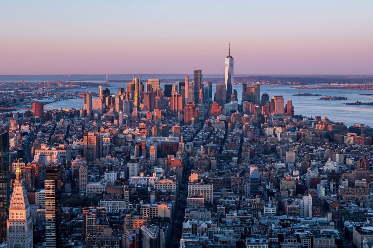 The Manhattan skyline is seen at sunrise.