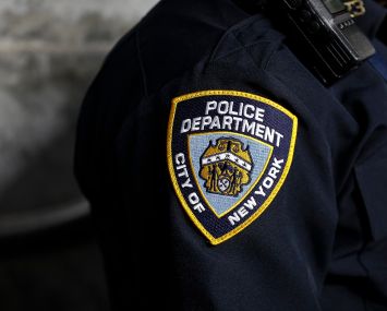 A New York City Police Department patch is seen on an officer's uniform.