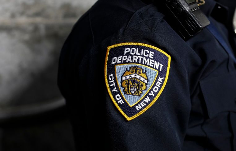 A New York City Police Department patch is seen on an officer's uniform.