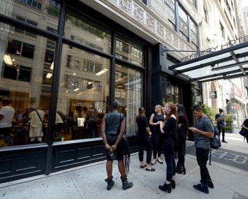 People wait outside the Refinery Hotel for an event.