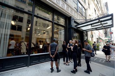 People wait outside the Refinery Hotel for an event.