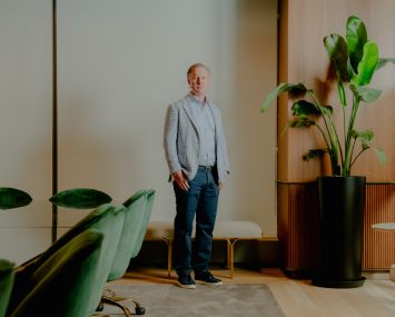 Wes Rogers stands in an office.