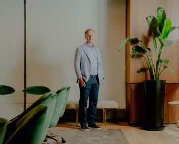 Wes Rogers stands in an office.