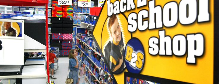 Shoppers peruse notebooks and other back-to-school items in a Walmart store.