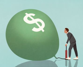 Image of a man blowing up a giant balloon with a dollar sign on it.