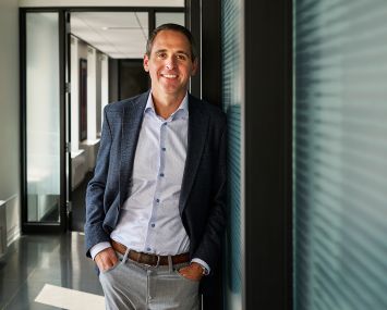 Andy Strand standing in an office.