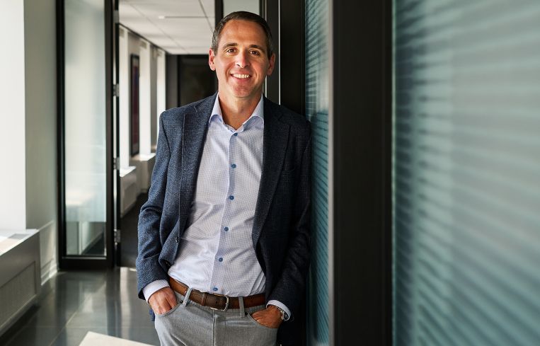 Andy Strand standing in an office.
