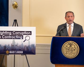 New York City Comptroller Brad Lander unveils a plan to fight corruption at a press conference.