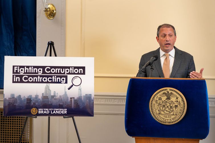 New York City Comptroller Brad Lander unveils a plan to fight corruption at a press conference.