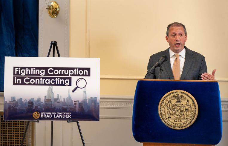 New York City Comptroller Brad Lander unveils a plan to fight corruption at a press conference.