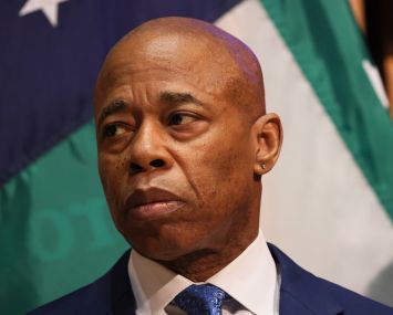 Mayor Eric Adams listens on during a press conference.