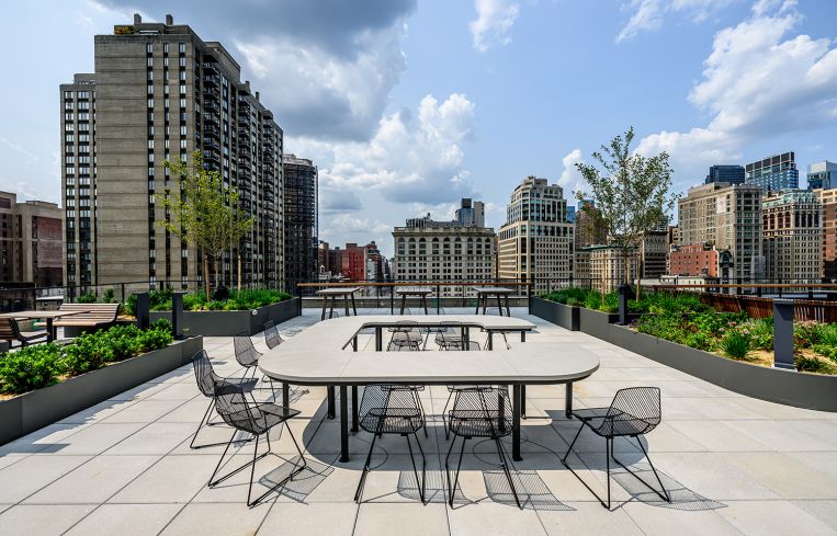 A large terrace with patio furniture and raised garden beds.