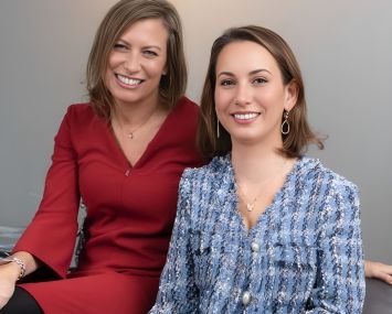 Two women, smiling.