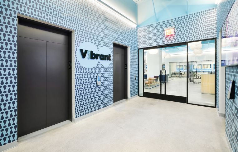 Custom wallpaper by 71 Visuals greats visitors stepping off the elevator.