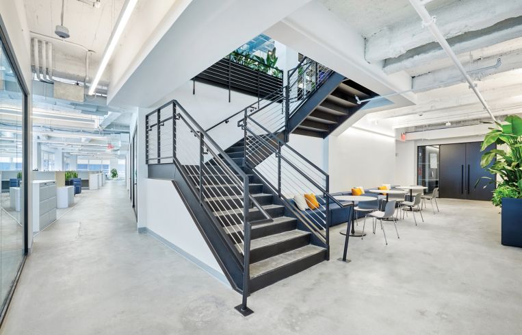 The office spans two full floors with mini lounge areas scattered throughout.