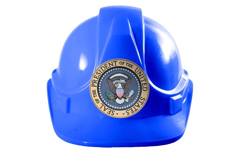 A blue hard hat with the United States' presidential seal on it.