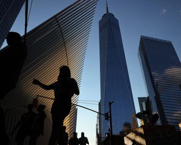 Pedestrians cross Church Street near One World Trade Center and the Oculus.