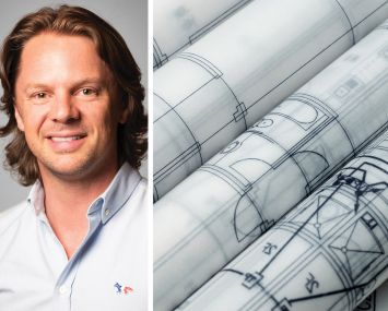 A man's face next to some rolled-up blueprints.